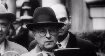 Movie still from “Zelig” (1983), directed by Woody Allen – A man in a hat and glasses is next to another man in a suit and tie; Close Up shot, Low angle
