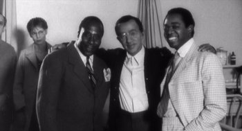 Movie still from “Zelig” (1983), directed by Woody Allen – A group of men standing next to each other; Medium shot, High angle