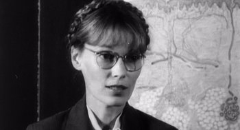 Movie still from “Zelig” (1983), directed by Woody Allen – A black and white photo of a woman wearing glasses; Close Up shot, Over the shoulder angle