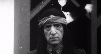 Movie still from “Zelig” (1983), directed by Woody Allen – An older man wearing a head dress and a tie; Close Up shot, High angle
