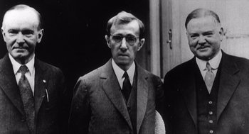 Movie still from “Zelig” (1983), directed by Woody Allen – A man in a suit and tie standing next to another man; Close Up shot, High angle