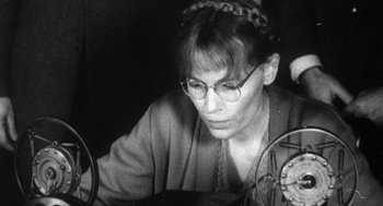 Movie still from “Zelig” (1983), directed by Woody Allen – An older woman wearing glasses looking at a computer screen; Close Up shot, Low angle