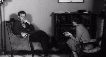 Movie still from “Zelig” (1983), directed by Woody Allen – A man and a woman sitting on a couch; Medium shot, Over the shoulder angle