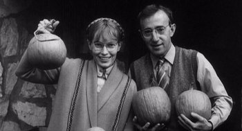 Movie still from “Zelig” (1983), directed by Woody Allen – A man and a woman holding pumpkins in a black and white photo; Medium shot, Overhead angle