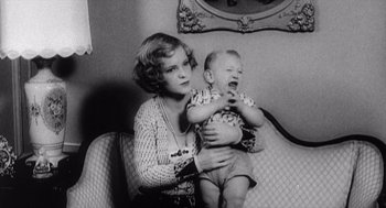 Movie still from “Zelig” (1983), directed by Woody Allen – An old photo of a woman holding a baby; Medium shot, High angle