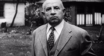 Movie still from “Zelig” (1983), directed by Woody Allen – An older man wearing a suit and a tie; Close Up shot, Low angle