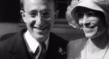 Movie still from “Zelig” (1983), directed by Woody Allen – An older man and woman smiling for the camera; Close Up shot, Low angle
