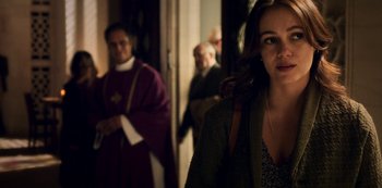 Movie still from “Archive 81” (2022), created by Rebecca Sonnenshine – A group of people standing in a room; Close Up shot, Over the shoulder angle