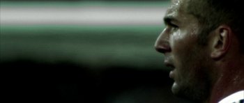 Movie still from “Zidane: A 21st Century Portrait” (2006), directed by Philippe Parreno – A man's face in a dark room; Extreme Close Up shot, Low angle