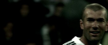 Movie still from “Zidane: A 21st Century Portrait” (2006), directed by Philippe Parreno – A blurry image of a person holding a keyboard; Extreme Close Up shot, High angle