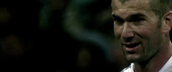 Movie still from “Zidane: A 21st Century Portrait” (2006), directed by Philippe Parreno – A man's face in the dark; Extreme Close Up shot, Over the shoulder angle