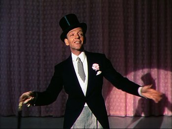 Movie still from “Ziegfeld Follies” (1945), directed by Roy Del Ruth – A man wearing a top hat and a suit; Medium shot, Low angle