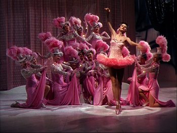 Movie still from “Ziegfeld Follies” (1945), directed by Roy Del Ruth – A group of women dressed in pink outfits; Wide shot, Low angle
