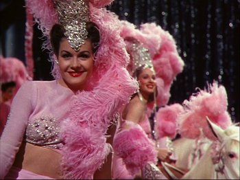 Movie still from “Ziegfeld Follies” (1945), directed by Roy Del Ruth – A group of women dressed up in pink costumes; Medium shot, Low angle