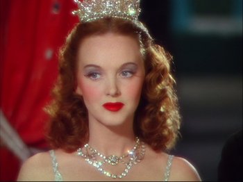 Movie still from “Ziegfeld Follies” (1945), directed by Roy Del Ruth – A woman in a tiara and a necklace; Close Up shot, Over the shoulder angle