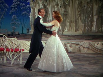 Movie still from “Ziegfeld Follies” (1945), directed by Roy Del Ruth – A man and a woman dancing in front of statues; Wide shot, Low angle