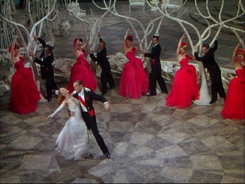 Movie still from “Ziegfeld Follies” (1945), directed by Roy Del Ruth – A group of people dressed in formal wear dancing; Wide shot, High angle