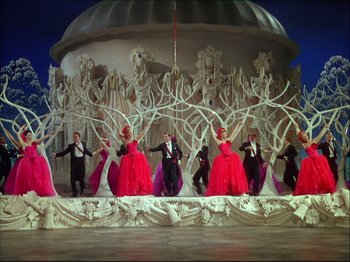 Movie still from “Ziegfeld Follies” (1945), directed by Roy Del Ruth – A group of men and women in formal wear standing in front of a dome; Wide shot, Low angle