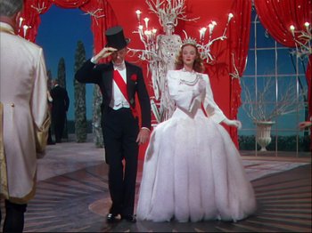 Movie still from “Ziegfeld Follies” (1945), directed by Roy Del Ruth – A man and a woman dressed in formal wear; Wide shot, Low angle
