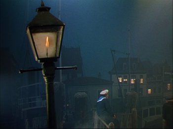 Movie still from “Ziegfeld Follies” (1945), directed by Roy Del Ruth – A lamp post with a lit candle in the middle of the night; Extreme Wide shot, High angle