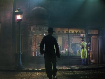 Movie still from “Ziegfeld Follies” (1945), directed by Roy Del Ruth – A man walking down the street in front of a store; Wide shot, Low angle