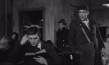 Movie still from “Zorba the Greek” (1964), directed by Michael Cacoyannis – A group of men standing next to each other in a room; Medium shot, Low angle