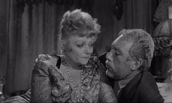 Movie still from “Zorba the Greek” (1964), directed by Michael Cacoyannis – An older man and a younger woman in a black and white photo; Close Up shot, High angle