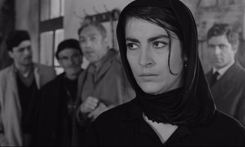 Movie still from “Zorba the Greek” (1964), directed by Michael Cacoyannis – A black and white photo of a woman in a black veil; Close Up shot, Low angle