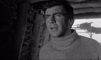 Movie still from “Zorba the Greek” (1964), directed by Michael Cacoyannis – A black and white photo of a man wearing a sweater; Close Up shot, Low angle