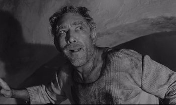 Movie still from “Zorba the Greek” (1964), directed by Michael Cacoyannis – Black and white photograph of a man with a messy face; Close Up shot, Low angle