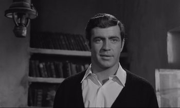 Movie still from “Zorba the Greek” (1964), directed by Michael Cacoyannis – A black and white photo of a man in a library; Close Up shot, Low angle
