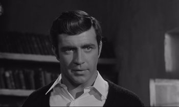 Movie still from “Zorba the Greek” (1964), directed by Michael Cacoyannis – Black and white photograph of a man in a white shirt; Close Up shot, Low angle