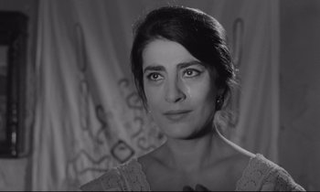 Movie still from “Zorba the Greek” (1964), directed by Michael Cacoyannis – Black and white photograph of a woman crying; Close Up shot, Low angle