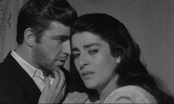Movie still from “Zorba the Greek” (1964), directed by Michael Cacoyannis – A man and a woman looking at each other; Close Up shot, High angle