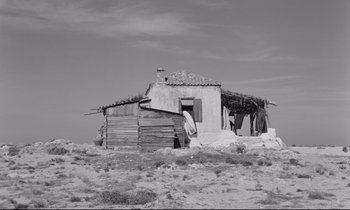 Movie still from “Zorba the Greek” (1964), directed by Michael Cacoyannis – An old house in the middle of a desert landscape; Extreme Wide shot, Low angle