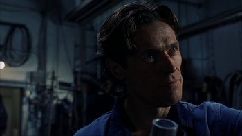 Movie still from “eXistenZ” (1999), directed by David Cronenberg – A person wearing a blue shirt; Close Up shot, Low angle