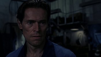 Movie still from “eXistenZ” (1999), directed by David Cronenberg – A person wearing a blue shirt; Close Up shot, Over the shoulder angle
