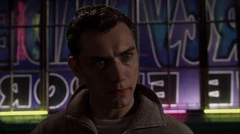 Movie still from “eXistenZ” (1999), directed by David Cronenberg – A young man is looking into the camera; Close Up shot, Low angle