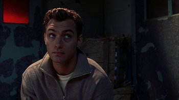 Movie still from “eXistenZ” (1999), directed by David Cronenberg – A man in a brown jacket looking up at the sky; Close Up shot, High angle