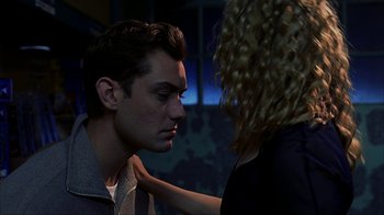 Movie still from “eXistenZ” (1999), directed by David Cronenberg – A man and a woman face to face in a dark room; Close Up shot, Low angle