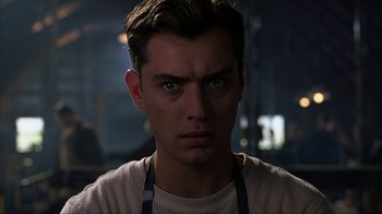 Movie still from “eXistenZ” (1999), directed by David Cronenberg – A person wearing a white shirt; Close Up shot, Low angle