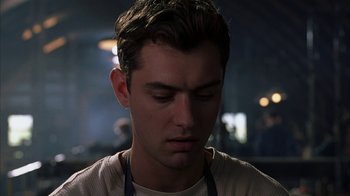 Movie still from “eXistenZ” (1999), directed by David Cronenberg – A person wearing a white shirt; Close Up shot, Low angle