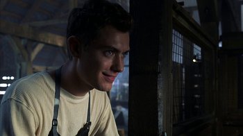 Movie still from “eXistenZ” (1999), directed by David Cronenberg – A young man is smiling for the camera; Close Up shot, Low angle