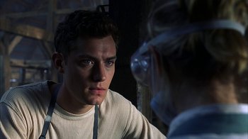 Movie still from “eXistenZ” (1999), directed by David Cronenberg – A man and a woman looking at one another; Close Up shot, Over the shoulder angle