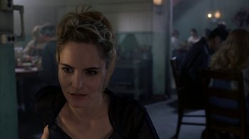 Movie still from “eXistenZ” (1999), directed by David Cronenberg – A beautiful woman with blonde hair in a room; Close Up shot, Over the shoulder angle