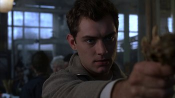 Movie still from “eXistenZ” (1999), directed by David Cronenberg – A young man is pointing his finger at the camera; Close Up shot, Low angle
