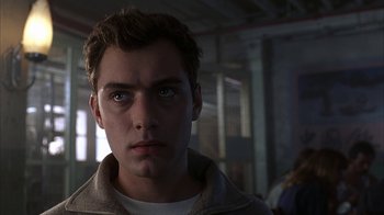 Movie still from “eXistenZ” (1999), directed by David Cronenberg – A young man stares into the camera; Close Up shot, Low angle