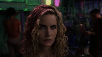 Movie still from “eXistenZ” (1999), directed by David Cronenberg – A person with curly hair; Close Up shot, Over the shoulder angle