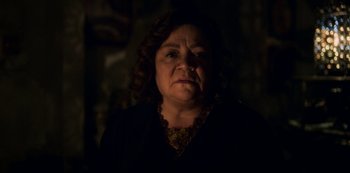 Movie still from “Archive 81” (2022), created by Rebecca Sonnenshine – A woman in a dark room with her eyes wide open; Close Up shot, Low angle