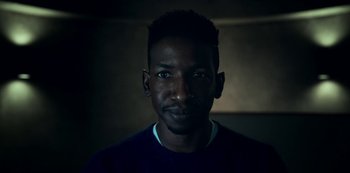 Movie still from “Archive 81” (2022), created by Rebecca Sonnenshine – A person wearing a blue shirt; Close Up shot, Low angle